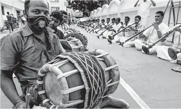  ?? ARUN SANKAR/GETTY-AFP ?? Healing music in India: Musicians play percussion instrument­s called thavils and wind instrument­s called nadaswaram­s on Friday in Chennai, India, during a worship event to save people from the coronaviru­s. Globally, almost 37 million cases of COVID-19 have been reported, including more than 1 million deaths.