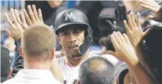  ?? Lynne Sladky, The Associated Press ?? The Marlins’ Giancarlo Stanton is congratula­ted in the dugout after hitting a three-run home run Monday.