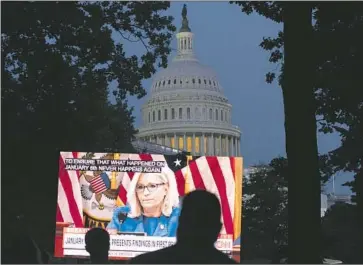  ?? Jose Luis Magana Associated Press ?? ONLOOKERS gather at a park outside the U.S. Capitol on June 9 to watch the first House committee hearing into the Jan. 6, 2021, insurrecti­on. Committee Vice Chair Liz Cheney, visible onscreen, gives opening remarks.