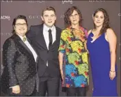  ?? Chris Delmas AFP / Getty Images ?? HONOREE Catherine Opie, left, arrives with family, including partner Julie Burleigh, second from right.