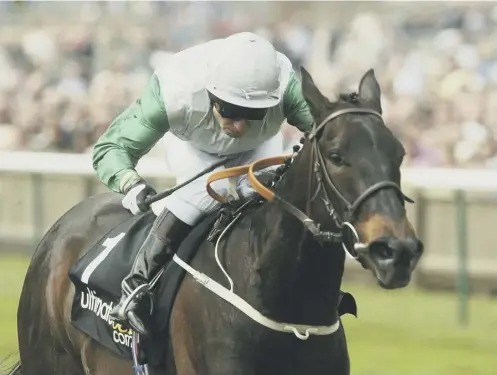  ??  ?? 2 Jockey Kevin Darley aboard Attraction on the way to victory in the 1000 Guineas at Newmarket in 2004.