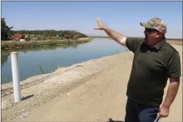  ?? ADAM BEAM — THE ASSOCIATED PRESS ?? Kevin Spesert, public affairs and real estate manager for the Sites Project Authority, points out the main canal of the Glenn Colusa Irrigation District near Sites on Friday. The canal would be one of the primary sources of water for the planned Sites Reservoir, a project that would be large enough to supply enough water for 1.5 million households each for one year.