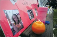  ?? CP FILE PHOTO ?? Lit candles and photograph­s are seen on display at a vigil for Calgary homicide victims Sara Baillie and her five-year-old daughter Taliyah Marsman in this July 2016 file photo.