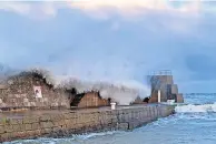  ?? BY LUCINDA CAMERON ?? HIGH TIDE Waves lash the pier wall at Lossiemout­h Harbour