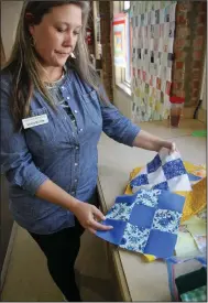  ?? ?? Valarie Nichols of Benton finished her first quilt (in the background) at QuiltMania, the Saline County Quilters Guild retreat, April 4-7. She plans to make her next quilt from the vintage material below.