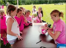  ?? GAVIN KEEFE/THE DAY ?? Former Waterford High School standout Katie Schoepfer, right, signs autographs on Thursday for campers at the Connecticu­t Coast Girls’ Soccer Clinic at Spera Field in Waterford.