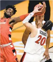  ?? AJ MAST AP ?? Syracuse forward Quincy Guerrier fights for a rebound with Aztecs guard Jordan Schakel on Friday.