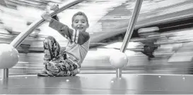  ?? Michael Ciaglo / Houston Chronicle ?? Max Duque, 6, spins around on a play structure on Friday in Levy Park. Houston’s holiday weather forecast isn’t looking good for outdoor play dates. Temperatur­es are expected to fall into the mid-20s on New Year’s Day.