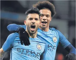  ??  ?? Sergio Aguero, left, celebrates his goal with Leroy Sane.