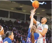  ?? NELL REDMOND/ASSOCIATED PRESS ?? South Carolina’s Ashlyn Watkins, right, shoots over Presbyteri­an’s Paige Kindseth during their NCAA Tournament first round game Friday in Columbia, S.C.