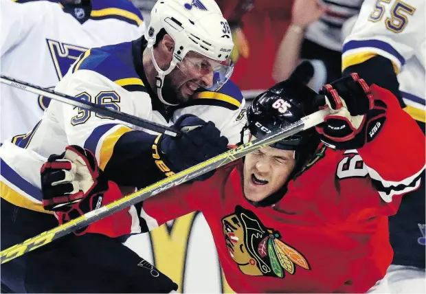  ?? NAM Y. HUH / THE ASSOCIATED PRESS FILES ?? Chicago winger Andrew Shaw is hit by St. Louis winger Troy Brouwer in the 2016 Stanley Cup playoffs. Despite calls from former stars Eric Lindros and Ken Dryden to ban bodychecki­ng, recent legal decisions would make that difficult, writes Scott Stinson.