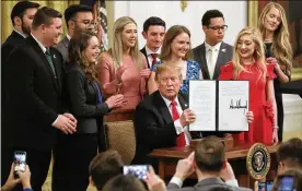  ?? CHIP SOMODEVILL­A / GETTY IMAGES ?? President Trump holds up an executive order he signed protecting freedom of speech on college campuses during a ceremony at the White House.