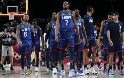  ??  ?? NBA star Kevin Durant (7) walks off the court with his USA teammates after their defeat to France. Photograph: Charlie Neibergall/AP