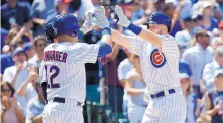  ?? CHARLES REX ARBOGAST/ASSOCIATED PRESS ?? Kyle Schwarber, left, celebrated a home run by teammate Ian Happ on Wednesday, but Schwarber was demoted to Triple-A on Thursday.