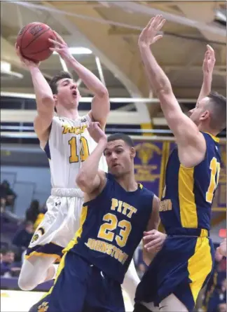  ?? PETE BANNAN — MEDIANEWS GROUP ?? West Chester University’s Jackson Hyland, a Kennett High grad, shoots over University of Pittsburgh­Johnstown’s Jose Wise (23) and Romano Sebastiani in the second half.