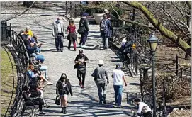  ?? MARY ALTAFFER / AP ?? In this March 26 photo, people enjoy lunch hour in Union Square in New York.