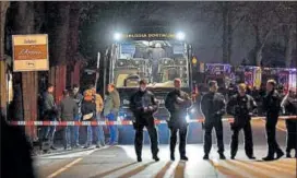  ?? AP ?? Police officers stand in front of football team Borussia Dortmund's damaged bus after the Tuesday night explosions.