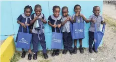  ??  ?? These young ones from the Little Folks Caring and Early Learning Center in Buff Bay, Portland, display the book bags they received from Books4Kids Jamaica last week.