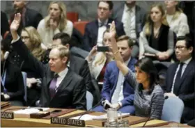  ??  ?? Matthew Rycroft, left, Britain’s Ambassador to the U.N., and U.S. Ambassador Nikki Haley vote Friday in favor of new sanctions against North Korea at United Nations headquarte­rs.