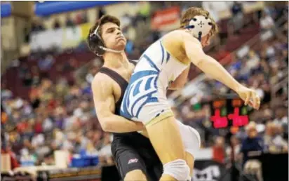  ?? NATE HECKENBERG­ER — FOR DIGITAL FIRST MEDIA ?? Garnet Valley’s Matt Marino lifts West Chester Rustin’s Brett Kaliner on his way to a 5-4 decision in the 126-pound blood round Friday at the PIAA Class 3A wrestling championsh­ips in Hershey. The victory assured Marino of his first state medal.