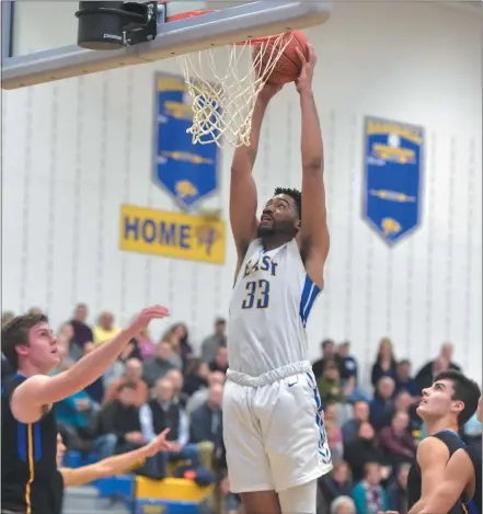  ?? PETE BANNAN — MEDIANEWS GROUP ?? Downingtow­n East’s Andrew King dunks two of his 30points in the Cougars’ 60-55victory over crosstown rival Downingtow­n West Tuesday evening.