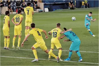  ??  ?? Barcelona’s Lionel Messi shoots at the Villarreal goal during their Spanish league match at the Madrigal stadium in Villarreal on Sunday. Barcelona won 4-1. — Reuters