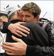  ?? TOM STRICKLAND / AP ?? JR Hildebrand (right) is consoled by Panther Racing owner John Barnes after Hildebrand crashed on the final turn of the 2011 race while trying to avoid a slower car and skidded across the finish line in second.