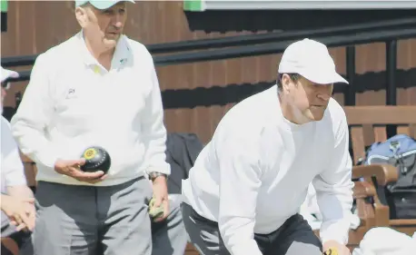  ??  ?? Marine A’s Alan Middleton bowling as Dairy Lane B skip Ian Lambert looks on