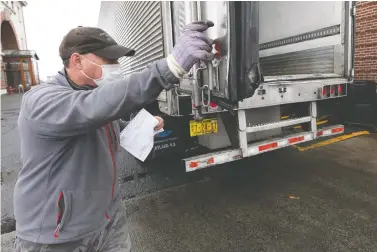  ?? MICHAEL DWYER/AP PHOTO ?? Trucker Tom Dixon, of Beaver River, N.S., prepares to return to Canada from Boston last month. “While little was done to make truck drivers’ work easier, the supply chain had to continue to function, seamlessly,” François Laporte writes.