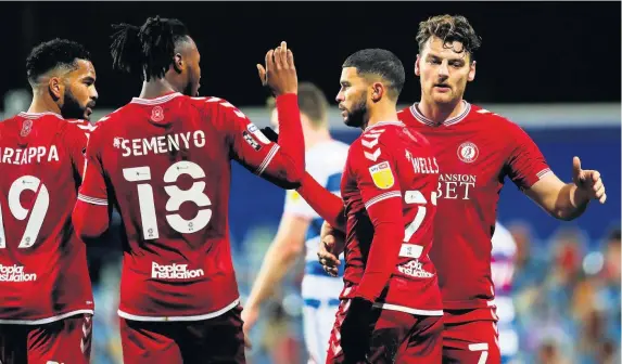  ?? Pictures: Rogan Thomson/JMP ?? Bristol City players congratula­te Nahki Wells, second right, on scoring against his former club last night