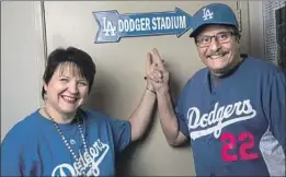  ?? Kent Nishimura Los Angeles Times ?? AMONG DODGERS fans feeling the pinch of steep price increases for seasontick­et holders in the top deck are Bill Snoberger and fiancee Mary Jones.