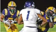  ?? BILL LACKEY/STAFF ?? Springfiel­d’s Anthony Brown looks for some running room as his teammate Jayvin Norman blocks Fairmont’s Kamron Payne during Friday’s game.