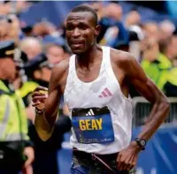  ?? JOHN TLUMACKI/GLOBE STAFF ?? Gabriel Geay was second, cheered by a group of Tanzanians who flew in for the race.