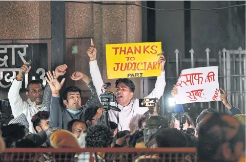  ?? REUTERS ?? People shout slogans outside Tihar Jail where four men convicted for the rape and murder of a woman in 2012, were hanged in New Delhi yesterday.