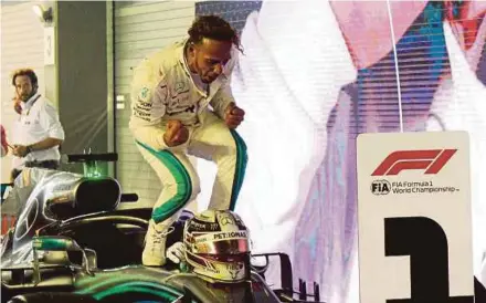  ?? AFP PIC ?? Mercedes driver Lewis Hamilton celebrates after winning the Singapore Grand Prix on Sunday.