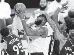  ?? MARK J. TERRILL AP ?? Lakers forward LeBron James is fouled by Golden State’s Kelly Oubre Jr.