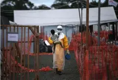  ??  ?? A Medecins Sans Frontieres worker carries a child suspected of having Ebola to an MSF treatment centre in Liberia (Getty)