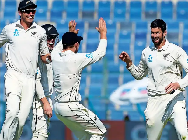  ?? — AFP ?? New Zealand spinner Will Somerville (right) celebrates with teammates after taking the wicket of Pakistan batsman Haris Sohail on the final day of the third Test in Abu Dhabi.