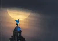  ?? ?? A full blue moon rises behind the Royal Liver Building on 30 August 2023 in Liverpool in the UK.
Photo: Christophe­r Furlong/getty Images