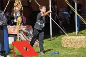  ?? MARIAN DENNIS – DIGITAL FIRST MEDIA ?? A boy takes part in friendly game of corn hole Saturday during the Ninth Annual Red Corner Benefit in Douglassvi­lle.