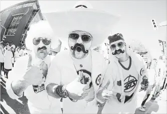  ?? CANADIAN PRESS FILE PHOTO ?? Aaron Wold, Shawn Machado and Jason Krucish make it clear who they’re cheering for before the Jets host the Vegas Golden Knights in Winnipeg on Saturday.