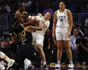  ?? RONALD MARTINEZ — GETTY IMAGES ?? The Sparks' Nneka Ogwumike (30) and the Lynx's Rachel Banham fight for the basketball during the fourth quarter on Sunday at Crypto.com Arena. The Sparks lost 84-77.