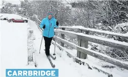  ??  ?? DOWNHILL ALL THE WAY Linda Norton uses her skis to get around CARRBRIDGE