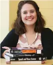  ?? TNS PHOTO ?? SMART CHOICE: Kay Caprez, a senior at Kent State University in Ohio, poses with her rented textbooks.