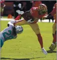  ?? NHAT V. MEYER — STAFF PHOTOGRAPH­ER ?? The 49ers’ Raheem Mostert tries to shake Miami’s Bobby McCain last Sunday en route to 90 yards rushing in a comeback from a knee injury.