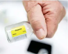  ?? — AFP file photo ?? A doctor holds a vial of ‘Thiopental’ a barbiturat­e that is used in the practice of euthanasia, in a hospital in Belgium.