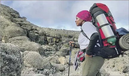  ?? Photograph­s by Jack Dolan Los Angeles Times ?? YUNIS MAUKY, one of the few female guides, timed our ascent perfectly as she helped lead us to the summit of Mt. Kilimanjar­o.