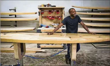  ??  ?? Tony Smith, owner of Jarvis Boards, laughs during an interview in his company’s workshop July 25.