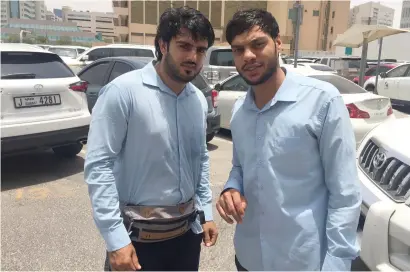  ?? (right) Supplied photo ?? Mushtaq Ahmed with a colleague at the Dubai Municipali­ty valet parking where he works. —