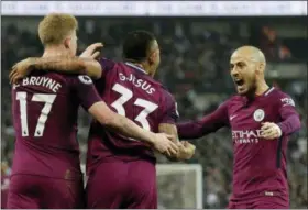  ?? TIM IRELAND — THE ASSOCIATED PRESS ?? Manchester City’s Gabriel Jesus celebrates with Kevin De Bruyne, left, and David Silva, right, after scoring the opening goal during the English Premier League soccer match between Tottenham Hotspur and Manchester City at Wembley stadium in London,...